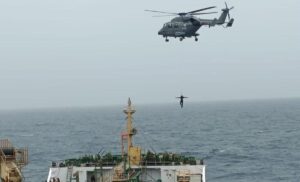 ALH Mk III Indian Coast Guard helicopter flying over ocean during maritime patrol