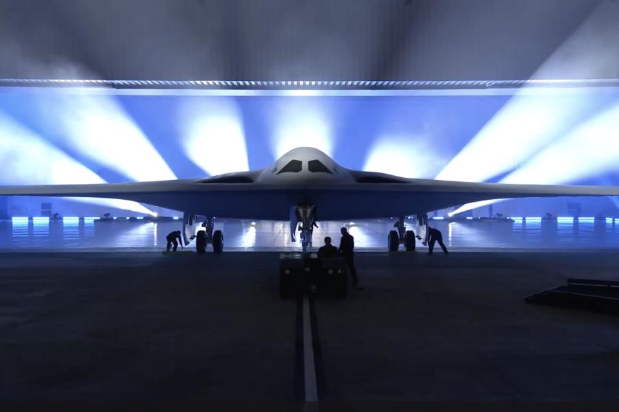 🛰️ Future Warfare Blueprint: Stealth, AI Targeting & Autonomous Systems Reshape Global Military Power B-21 Raider stealth bomber in hangar with futuristic design and low-observable stealth features under lighting