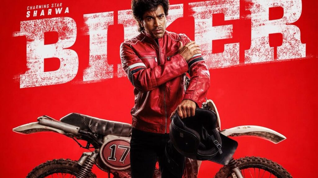 Sharwanand in Biker Telugu movie poster holding helmet with motocross bike in red background