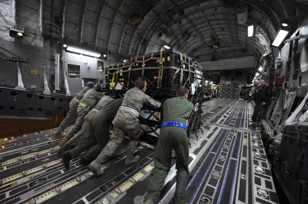 Interior view of C-130J cargo bay with soldiers and equipment ready for deployment