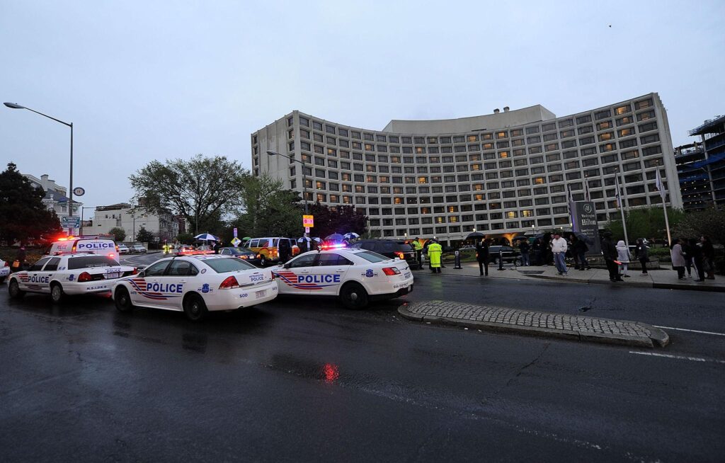 Police and emergency vehicles outside Washington Hilton after reported shooting incident