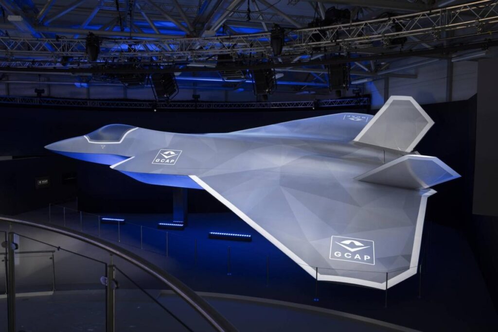 🛰️ Future Warfare Blueprint: Stealth, AI Targeting & Autonomous Systems Reshape Global Military Power GCAP sixth-generation fighter jet concept model displayed with futuristic stealth design and next-generation air combat features