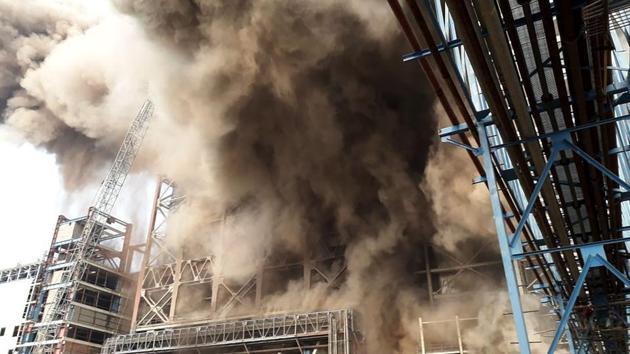 Industrial power plant explosion with heavy smoke rising from boiler unit
