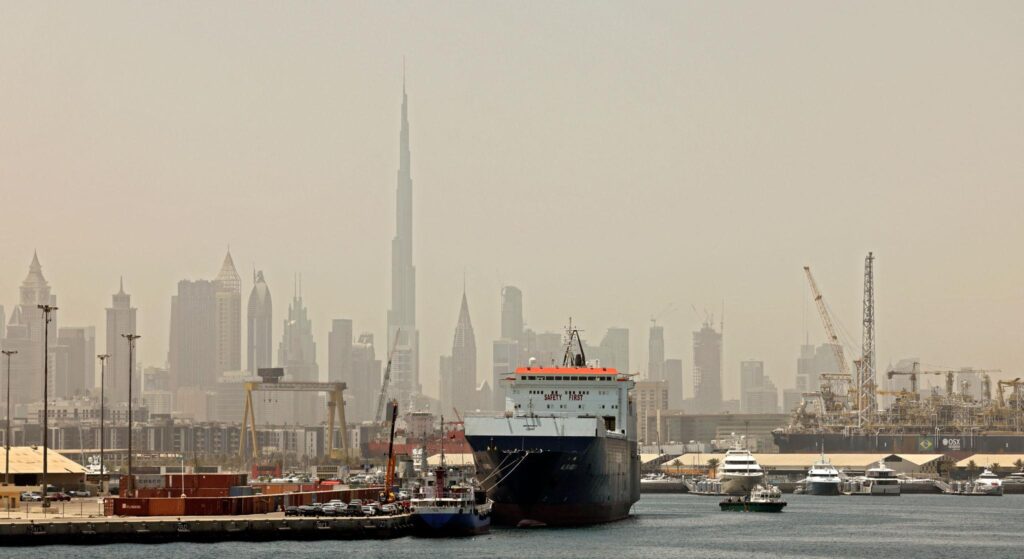 Oil tankers, cargo containers and UAE skyline representing India-UAE trade and energy cooperation.