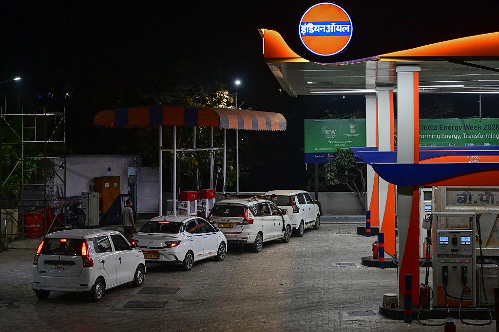 Indian consumers at petrol stations amid rising fuel price pressure.