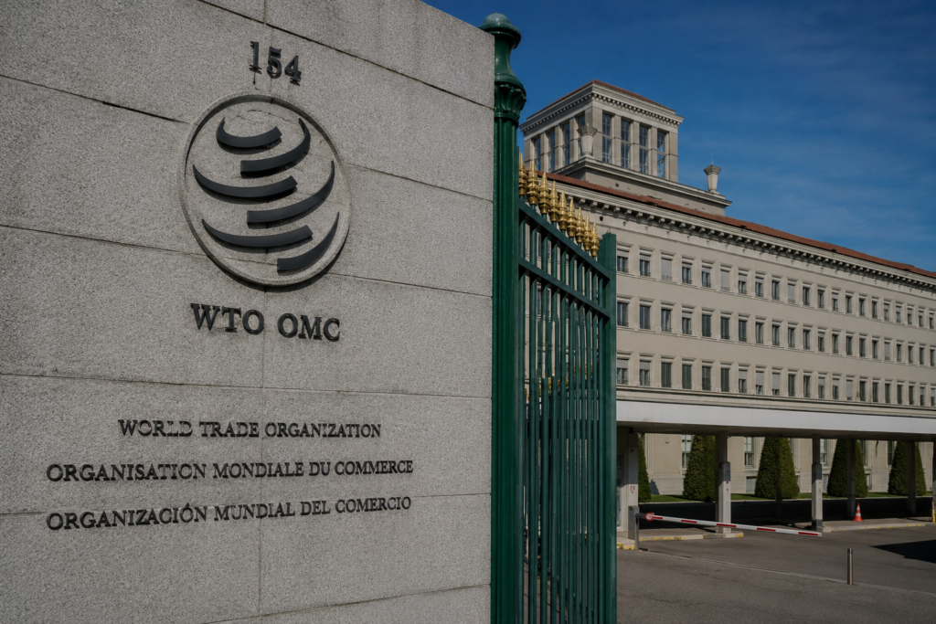 World Trade Organization headquarters building in Geneva with WTO logo displayed at the main entrance gate.