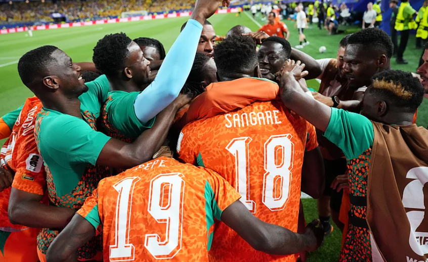 Ivory Coast players surround Amad Diallo after his late winning goal against Ecuador during the FIFA World Cup 2026 Group E match