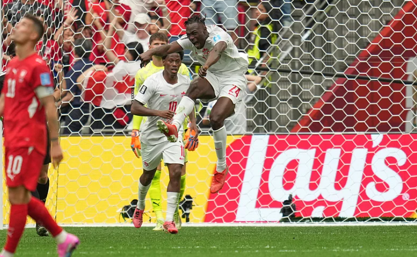 Promise David celebrates scoring for Canada