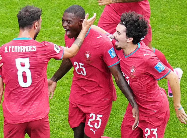Nuno Mendes celebrates with Bruno Fernandes and Vitinha after scoring for Portugal
