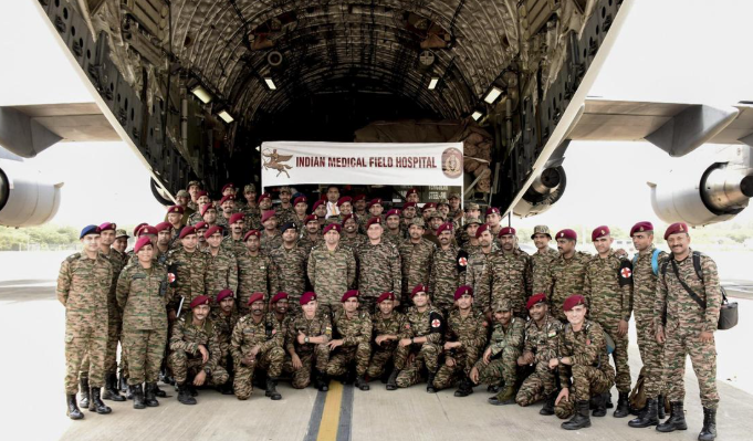 Indian Armed Forces personnel pose in front of an Indian Medical Field Hospital before departing on Operation Amistad to deliver earthquake relief to Venezuela.