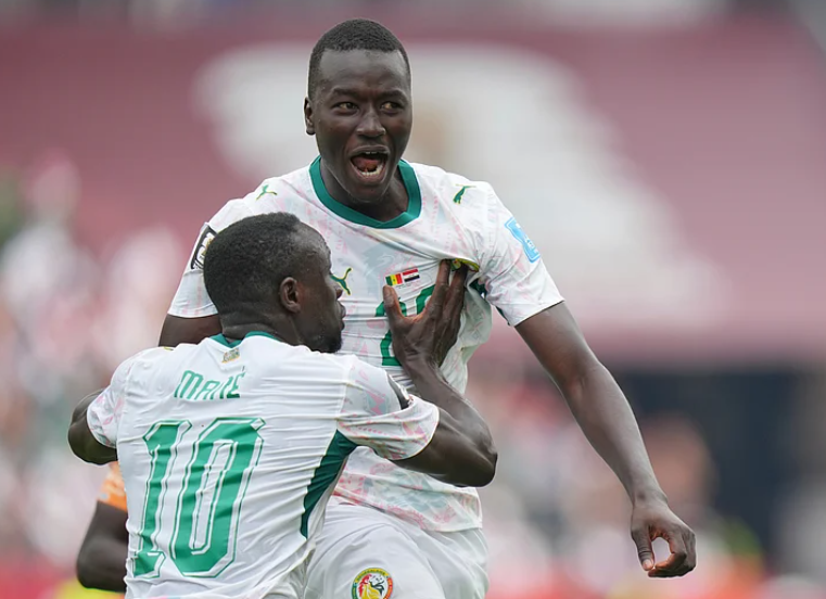 Pape Gueye celebrates with Sadio Mane after scoring Senegal third goal against Iraq
