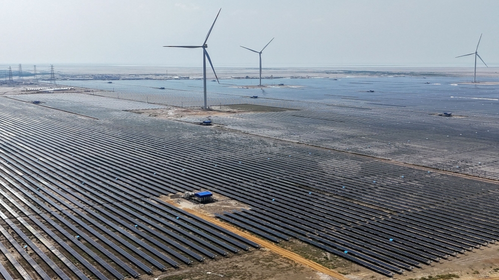 From Barren Desert to Renewable Energy Superpower: Inside India's $30 Billion Khavda Mega Project Large wind turbines operating at the Khavda Renewable Energy Park in Gujarat.