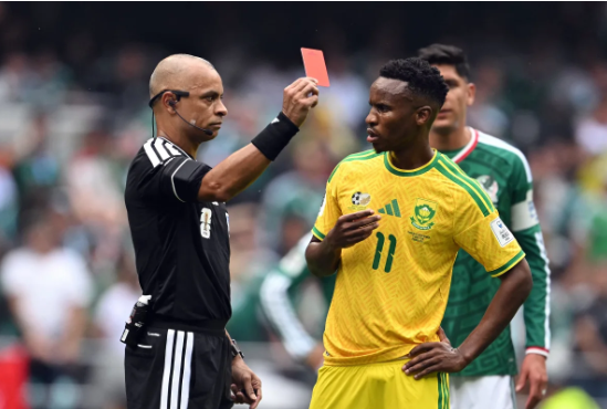Referee Wilton Sampaio shows a red card to South Africa