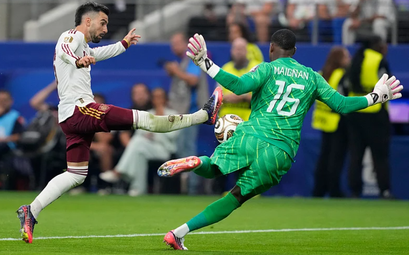 Spain midfielder Alex Baena attempts to score against France goalkeeper Mike Maignan during the World Cup semifinal