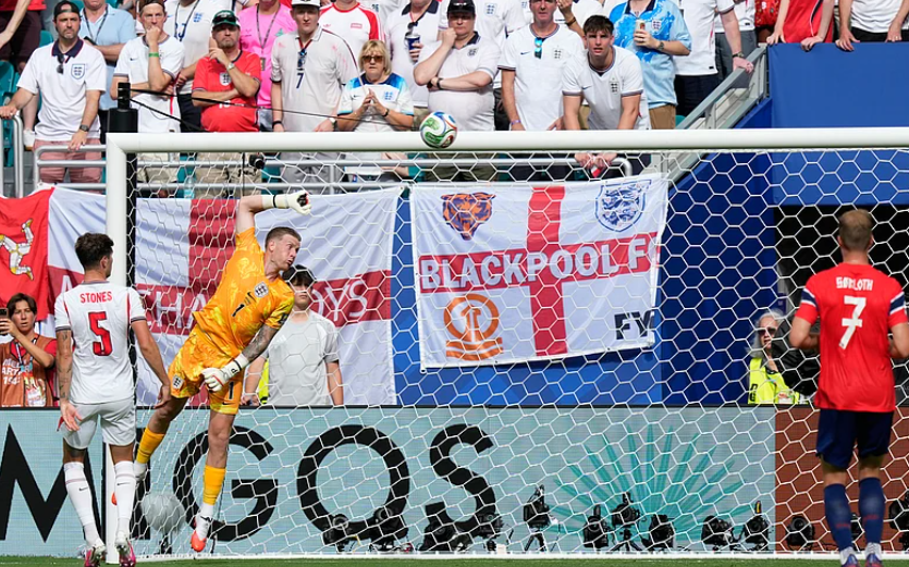 England goalkeeper Jordan Pickford dives but cannot stop Andreas Schjelderup