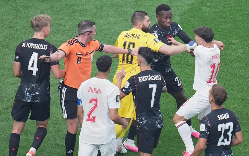 Canada goalkeeper Maxime Crepeau separates Stephen Eustaquio and Morocco