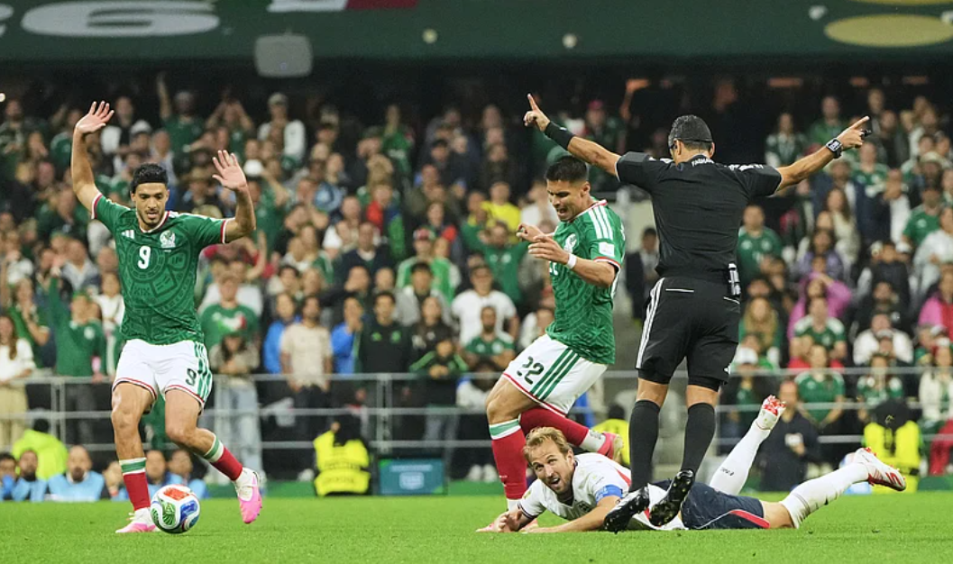 Referee Alireza Faghani gestures as Harry Kane goes down during the Mexico vs England FIFA World Cup 2026 Round of 16 match