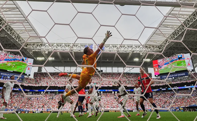 England goalkeeper Jordan Pickford leaps toward the ball as it strikes the crossbar against Norway