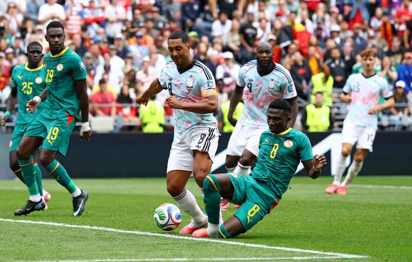 Senegal midfielder Lamine Camara fouls Belgium captain Youri Tielemans inside the penalty area during the FIFA World Cup 2026 Round of 32 match