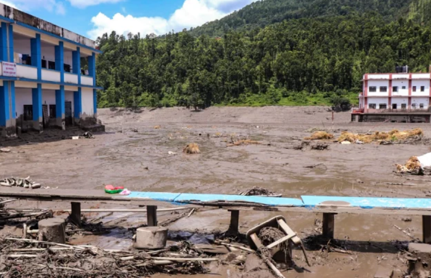 Damaged bridge surrounded by mud and debris after severe flooding in Nepal