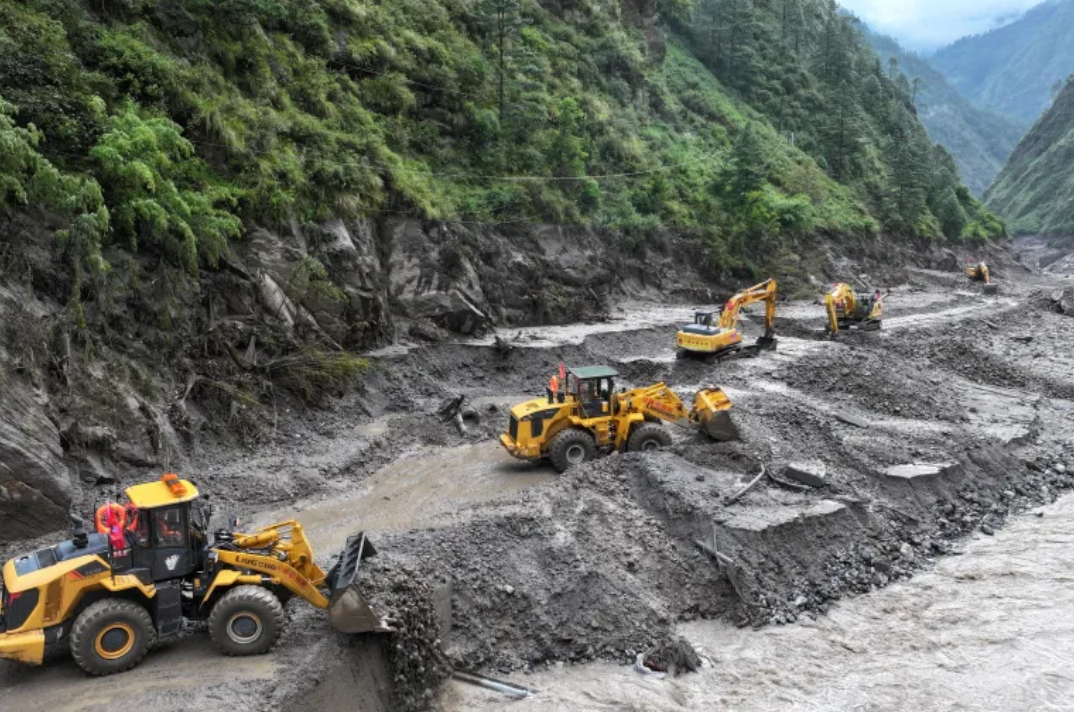 Excavators removing mud and debris during Nepal flood rescue operations