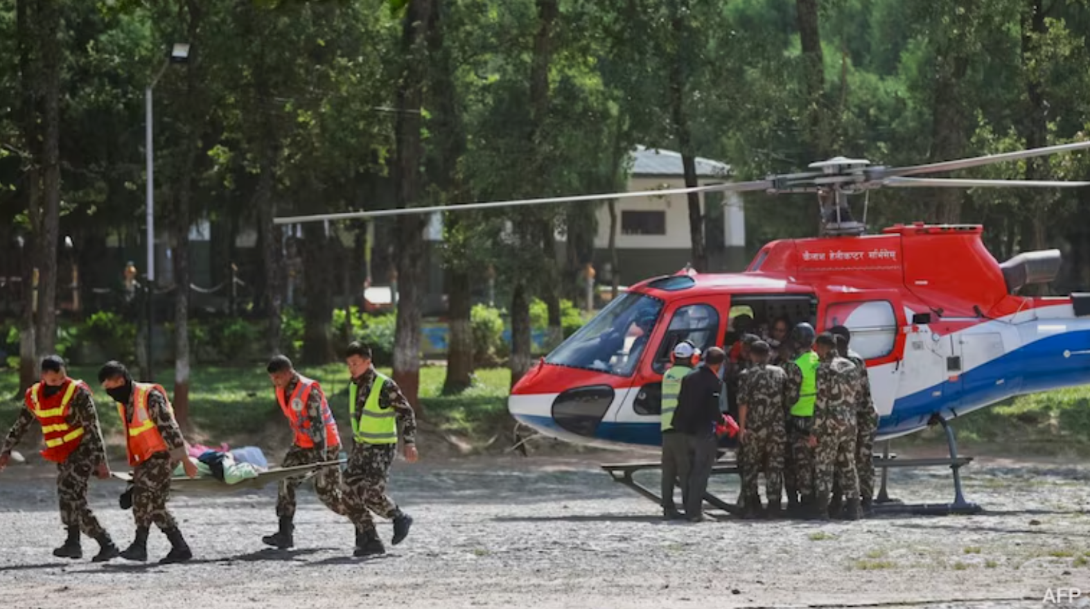 Rescue personnel transporting an injured person during Nepal flood operations