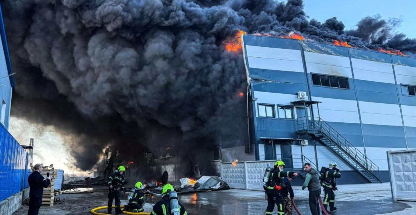 Dense black smoke and flames rise from a warehouse struck by a Russian drone near Kyiv on August 29, 2026