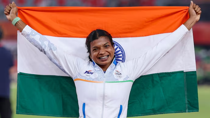 Baranica Elangovan celebrates with the Indian flag after winning the women’s pole vault bronze at the Asian Games 2026