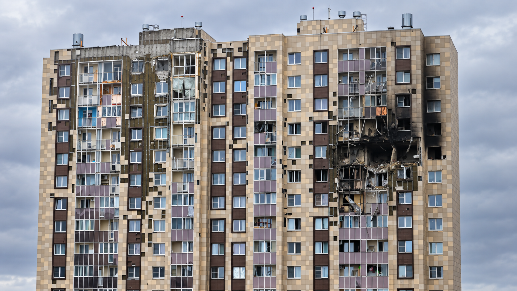High-rise apartment building with shattered windows and extensive damage after a reported Ukrainian drone strike in the Moscow region.