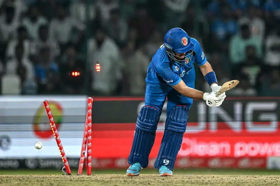 Afghanistan batter Darwish Rasooli is bowled as the ball breaks the stumps behind him