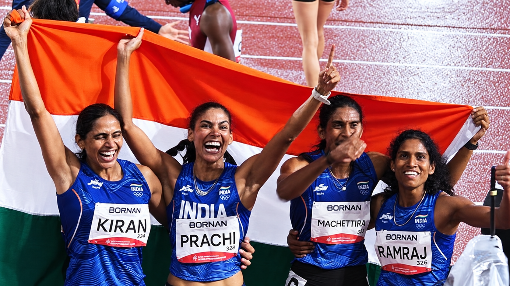 Kiran Pahal, Prachi, M.R. Poovamma and Vithya Ramraj celebrate with the Indian tricolour.