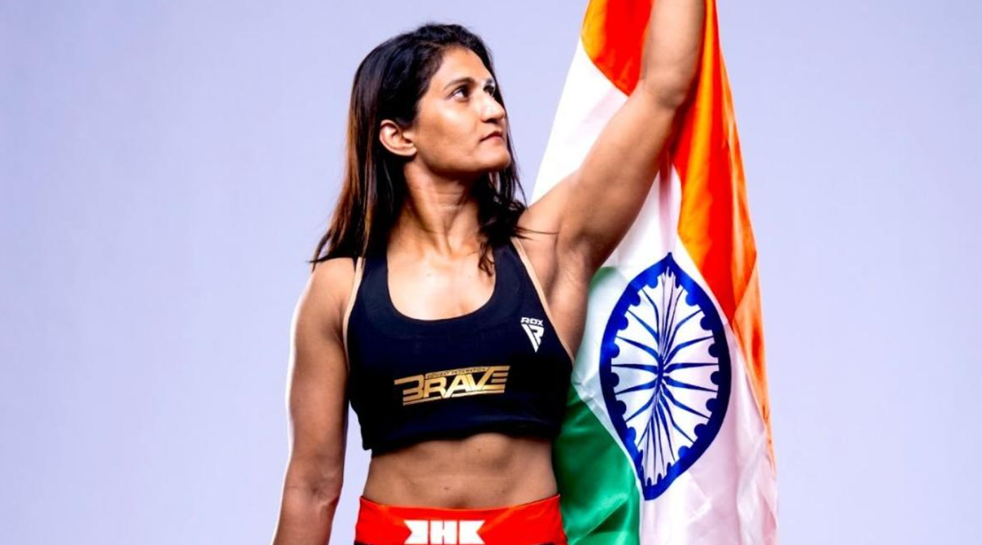 Indian MMA athlete Suchika Tariyal poses with the national flag