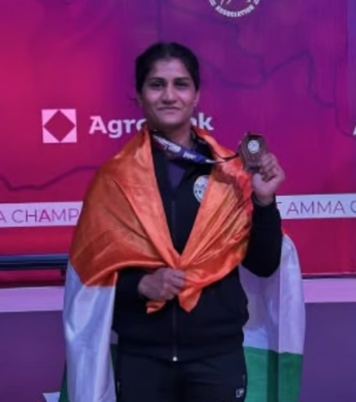 Indian MMA fighter Suchika Tariyal displays her bronze medal while draped in the national flag at the Asian Games 2026