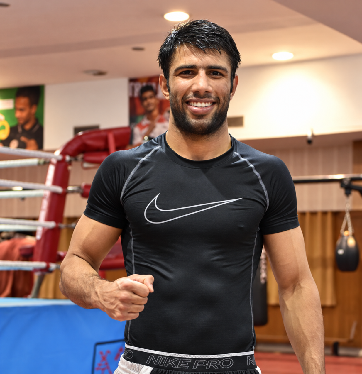 Indian boxer Sumit Kundu poses inside a boxing training gym