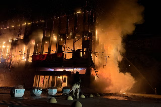 Firefighters use an aerial ladder to tackle a fire inside Zaporizhzhia National University after a Russian drone strike.