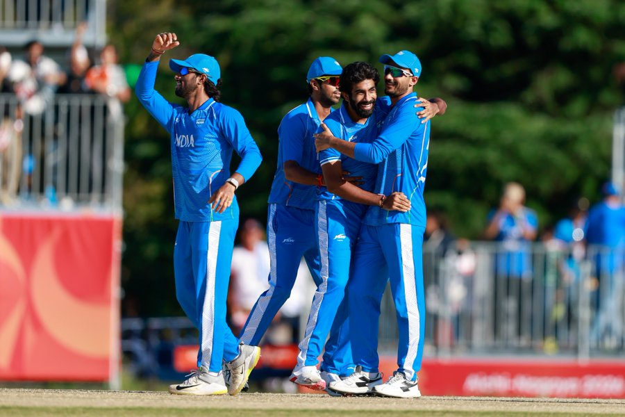 Indian teammates celebrate with Jasprit Bumrah after a wicket against Sri Lanka.